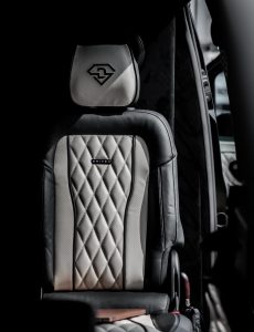Rear-facing bench seat with flip-down centre armrest and cup